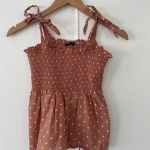 Nude pink tank top with white polka dots with tie straps size Small.